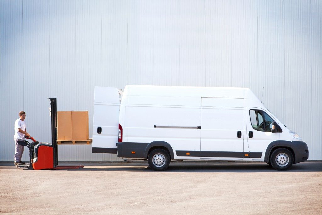 Worker loading packages in a sprinter van
