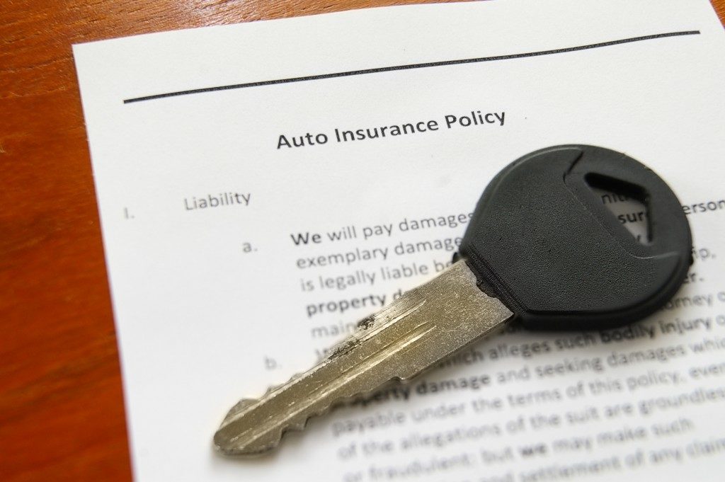 car key on auto insurance policy
