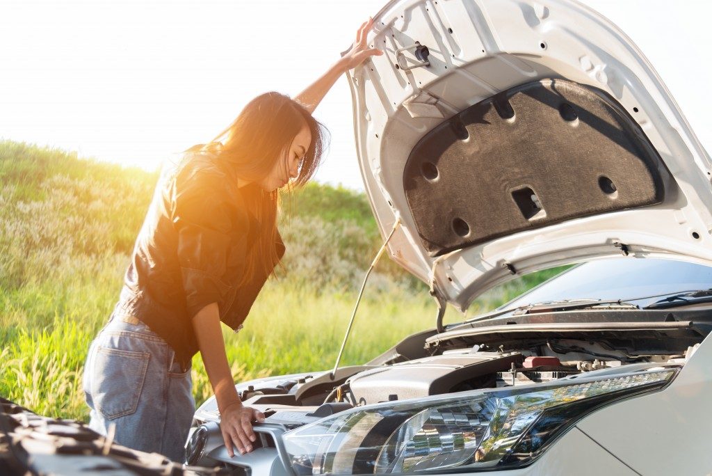 woman checking her car engine