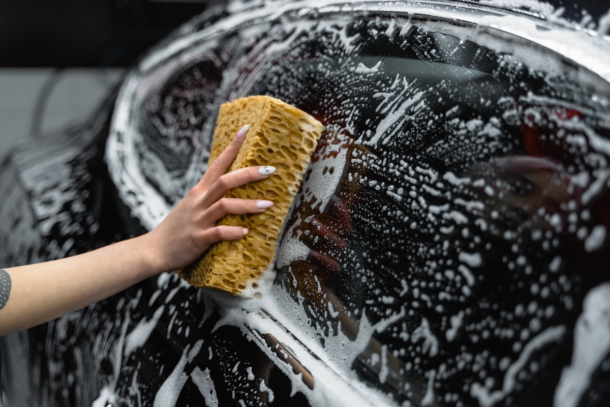 cleaning car with sponge