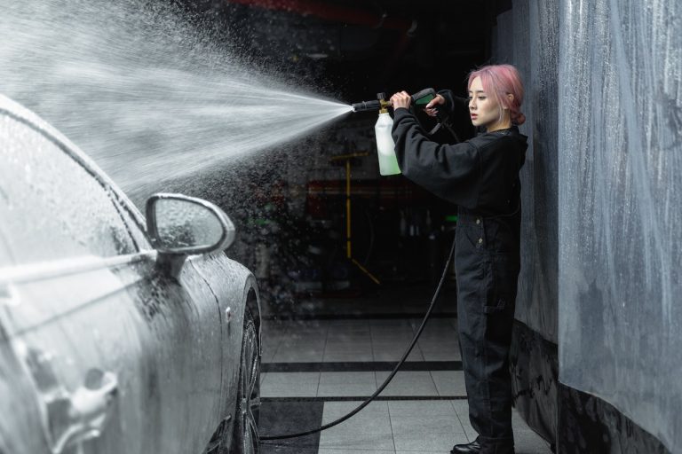 worker cleaning a car