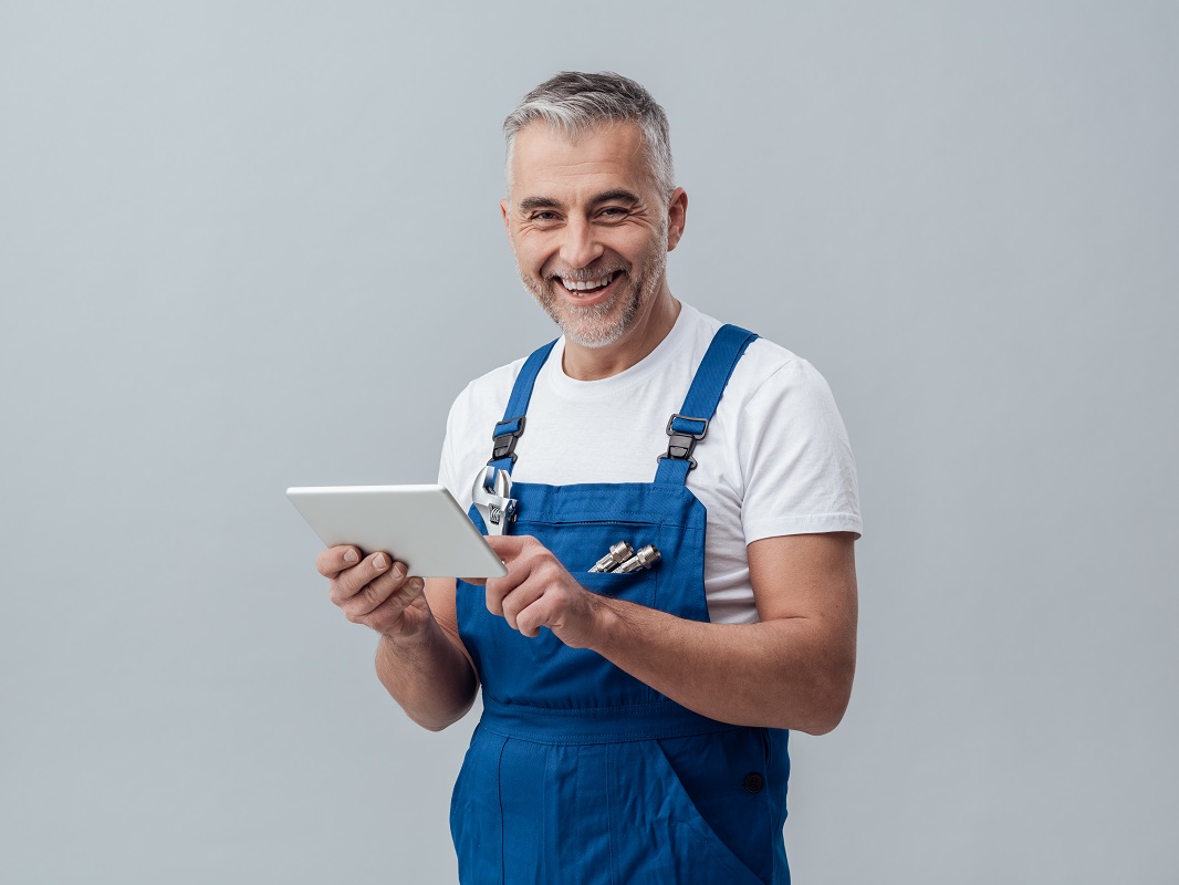 man holding a tablet smiling
